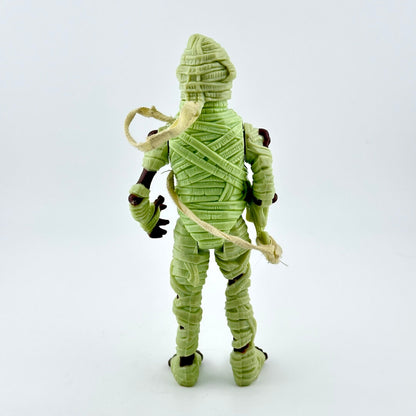 Green mummy figurine on a white background