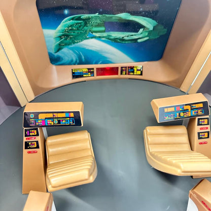 Control panel with futuristic design and screen displaying a spaceship.