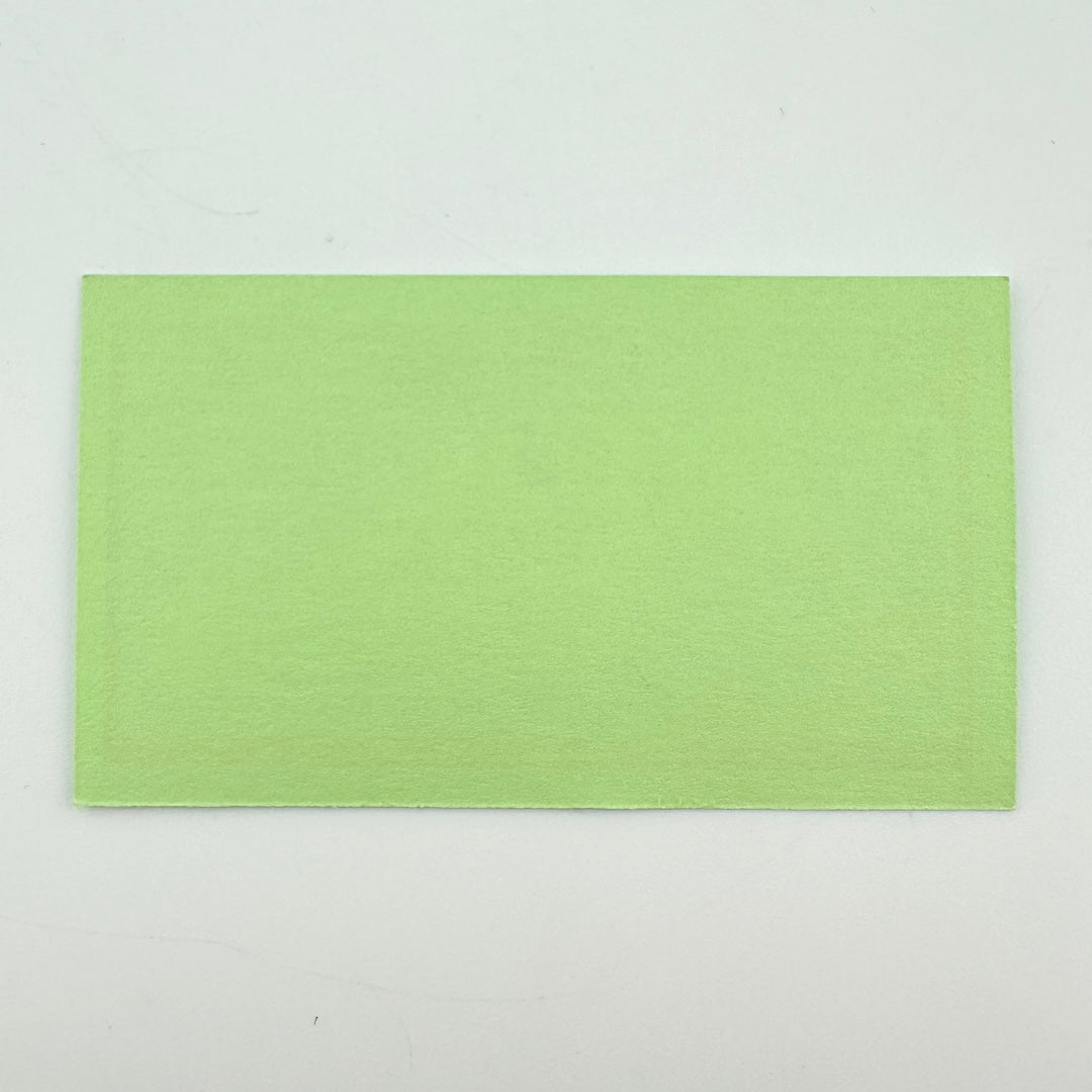 Backside of green rectangular pass with no graphics or damage. 