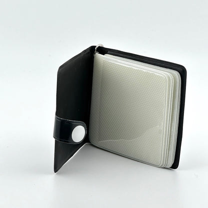 black booklet with snap closure and six photo sleeve pages with zero use or damage. 