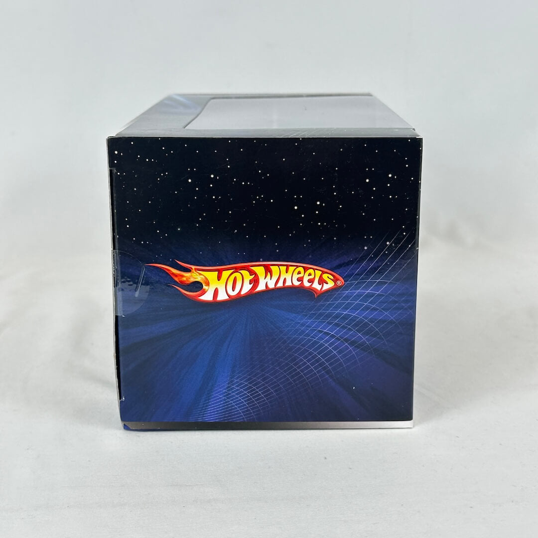 Side view of ship packaging featuring Hot Wheels branding on blue and black background. 