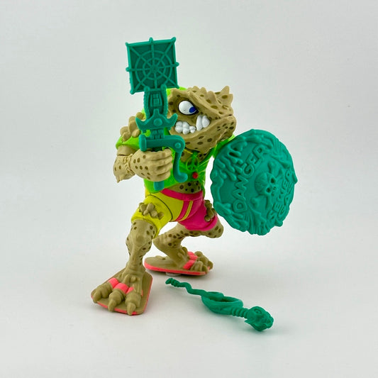 Anthropomorphized frog action figure wearing yellow & pink shorts, with three teal accessories, front side view.