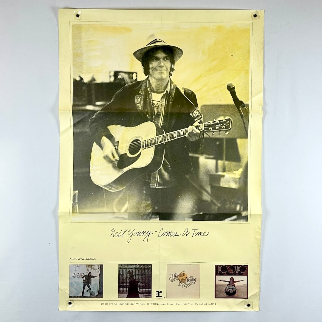 Poster of a musician holding an acoustic guitar with album cover images at the bottom.