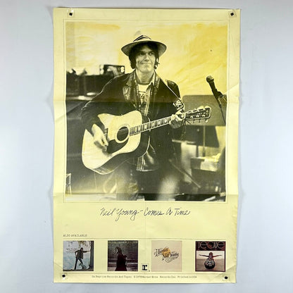 Poster of a musician holding an acoustic guitar with album cover images at the bottom.