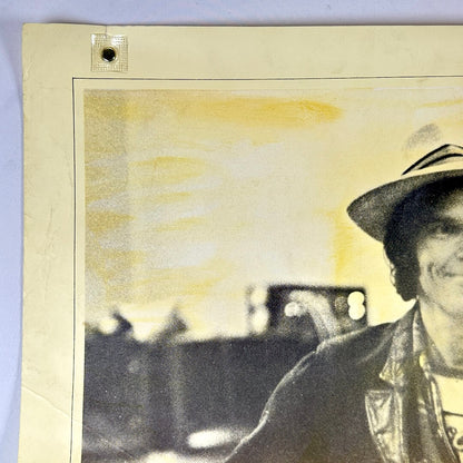 Top left corner of poster with edge wear along long side. 