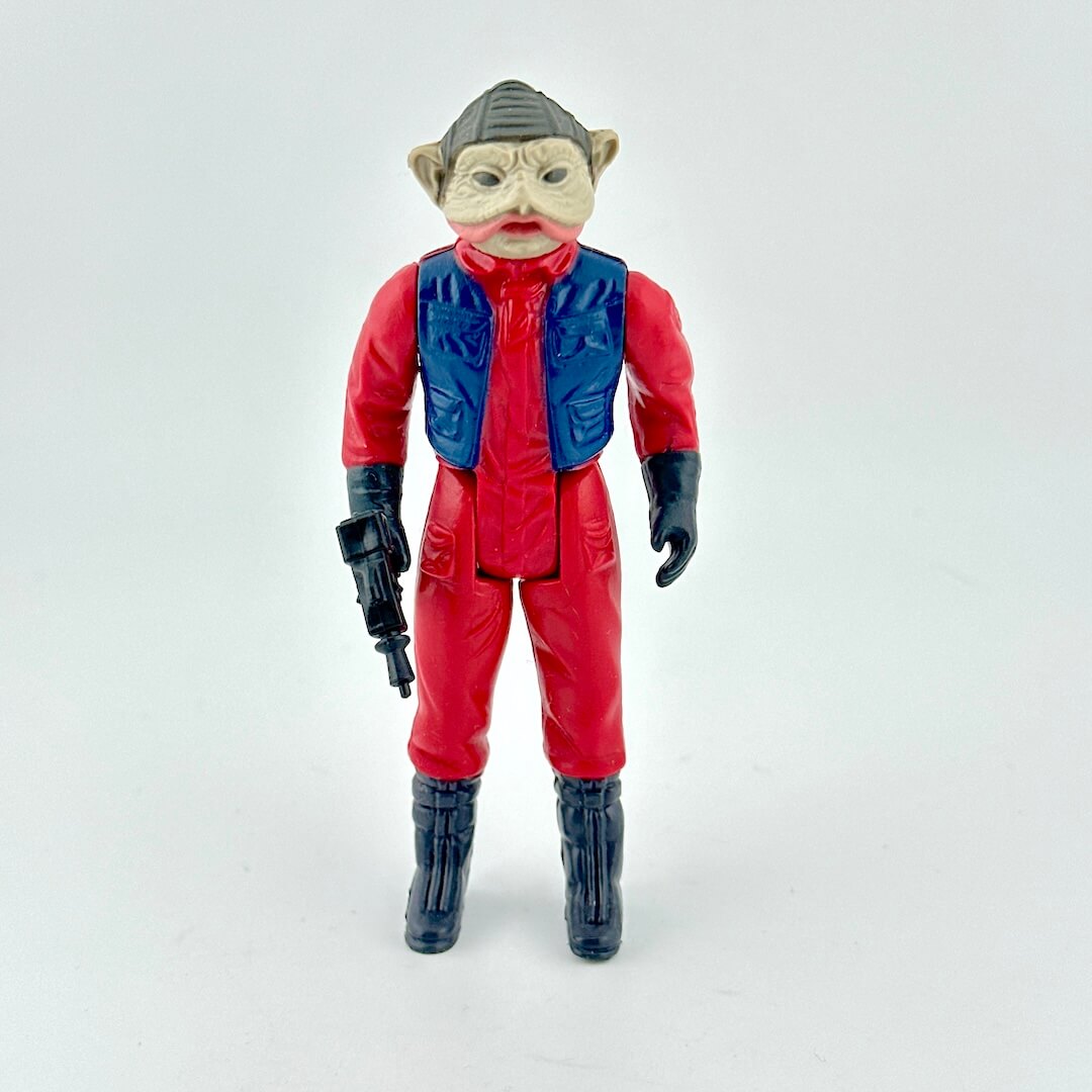 Toy figure in red and blue outfit with helmet on a white background