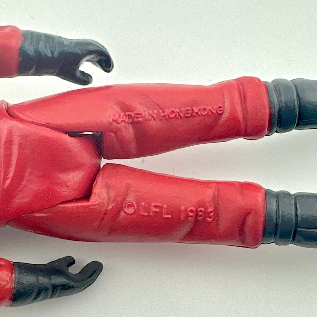 Back of figure's legs to show COO and copyright information. 