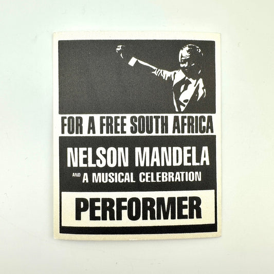 A square black and white printed pass featuring a portrait of Nelson Mandela raising his hand, with the text 'FOR A FREE SOUTH AFRICA'