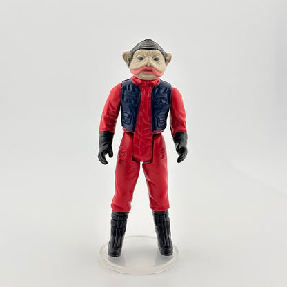 Image of 3-inch alien figure with grey wrinkled skin & pink mouth in a red flight suit, navy vest, black boots and gloves.