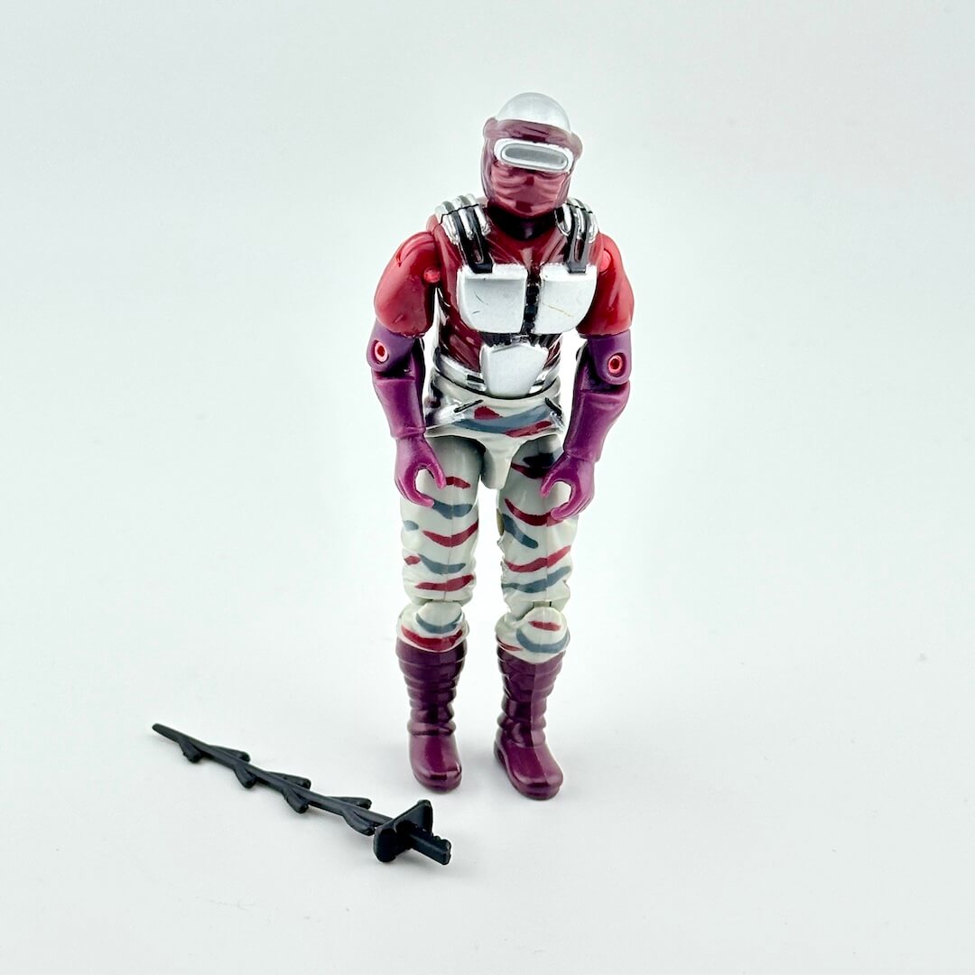 Toy figure in a red and white outfit with a helmet on a white background
