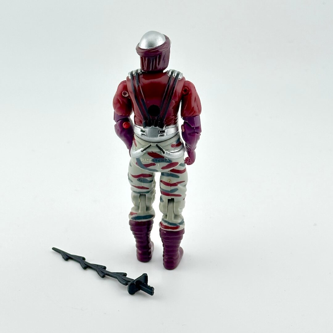 Action figure with red and silver helmet, purple gloves, and striped pants on a white background