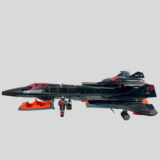 Toy spaceship with a smaller figure in front on a light gray background