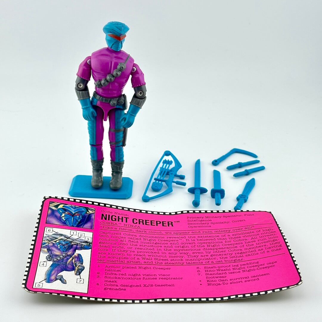G.I. Joe action figure with accessories and character card against white background.