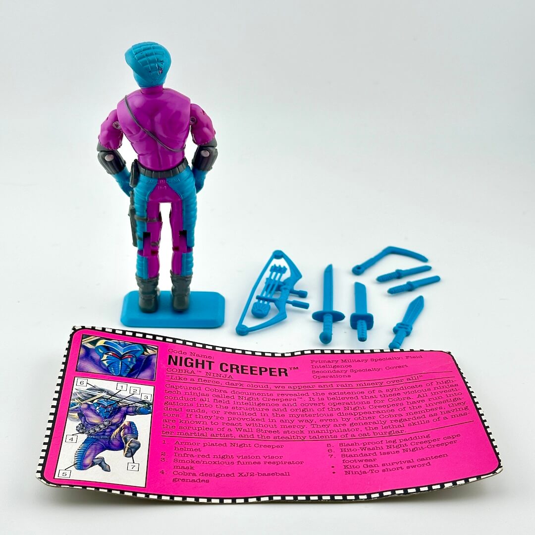 G.I. Joe action figure with accessories and character card against white background.