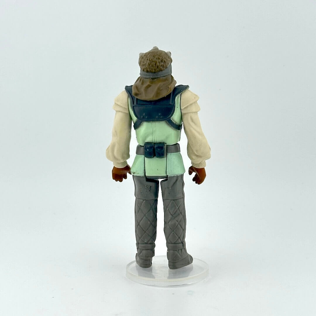 Action figure with a green vest and gray pants on a white background