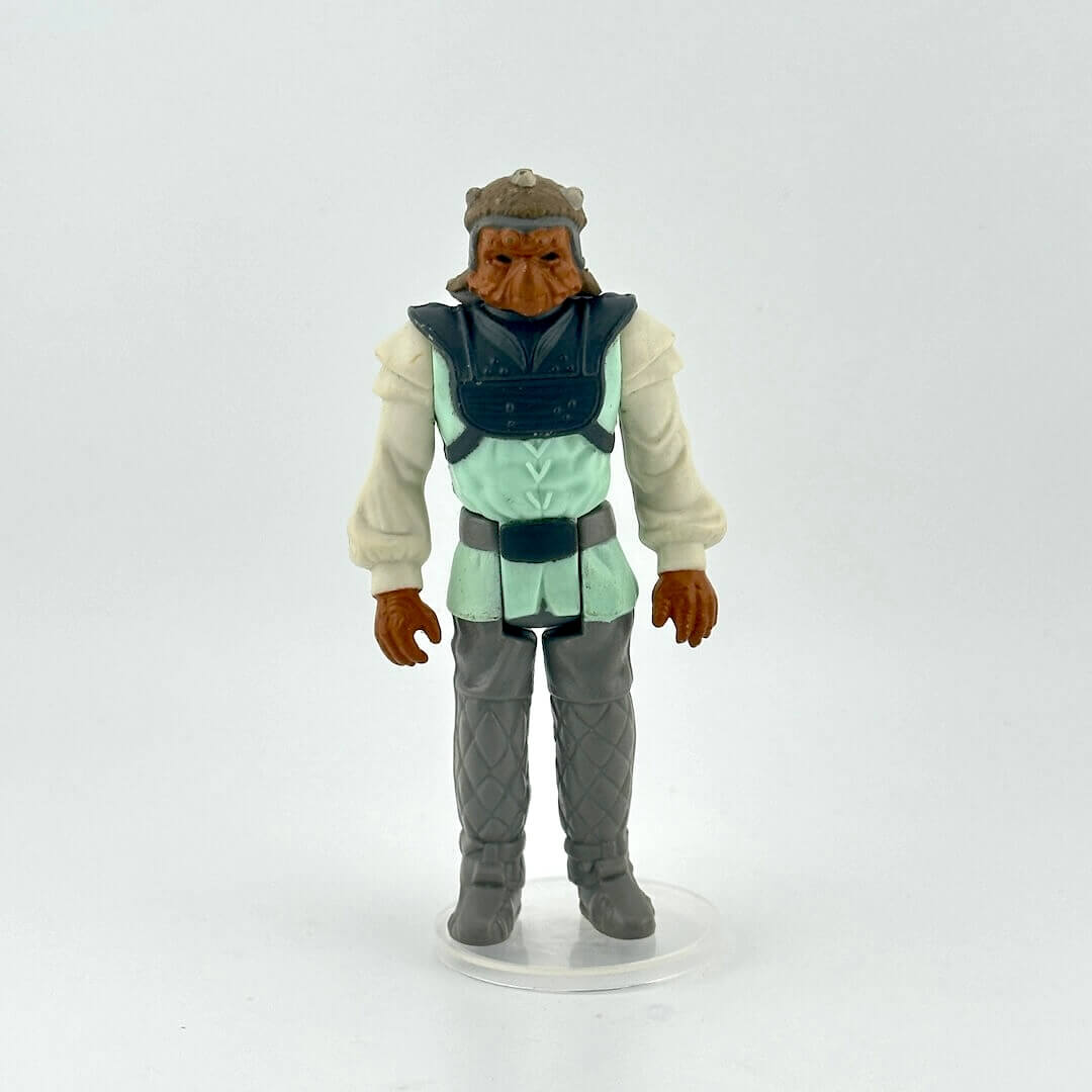 Action figure with a green outfit and hat on a white background