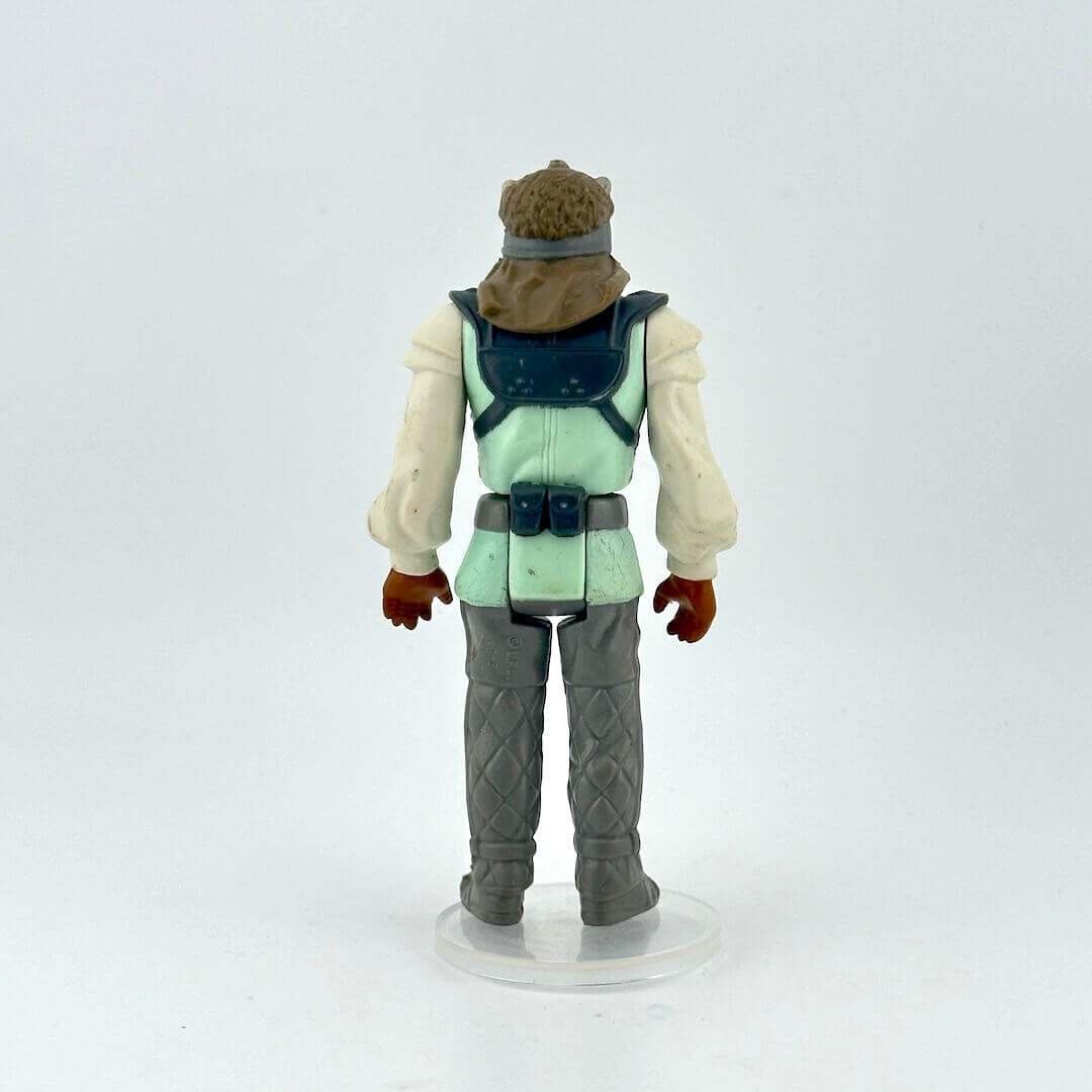 Action figure with a green vest and gray pants on a white background