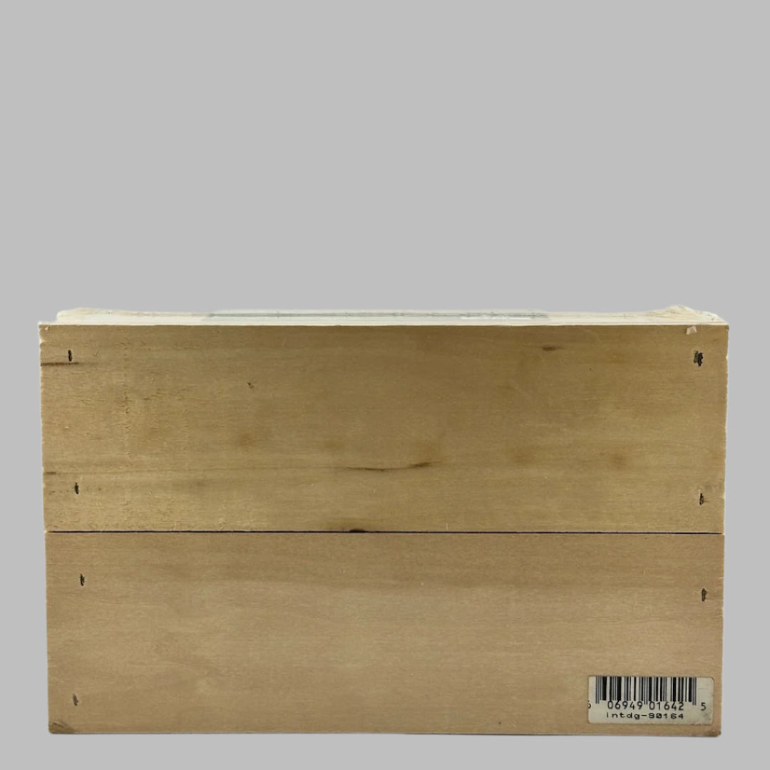 Plastic wrapped wooden fruit crate with blue label on side, & fake oranges in top. Back view.