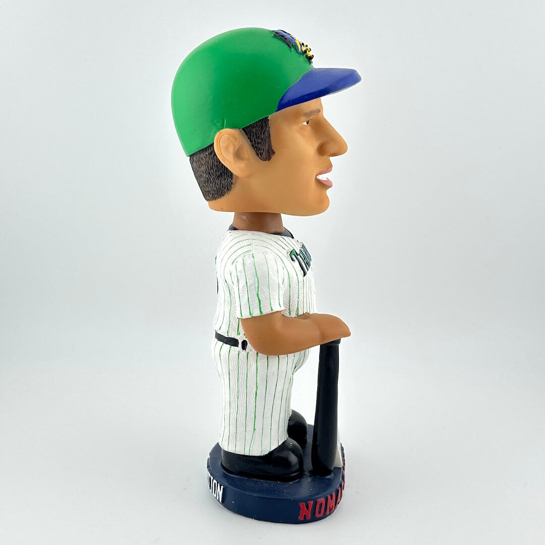 Bobblehead figure of a baseball player wearing a green and blue cap on a white background