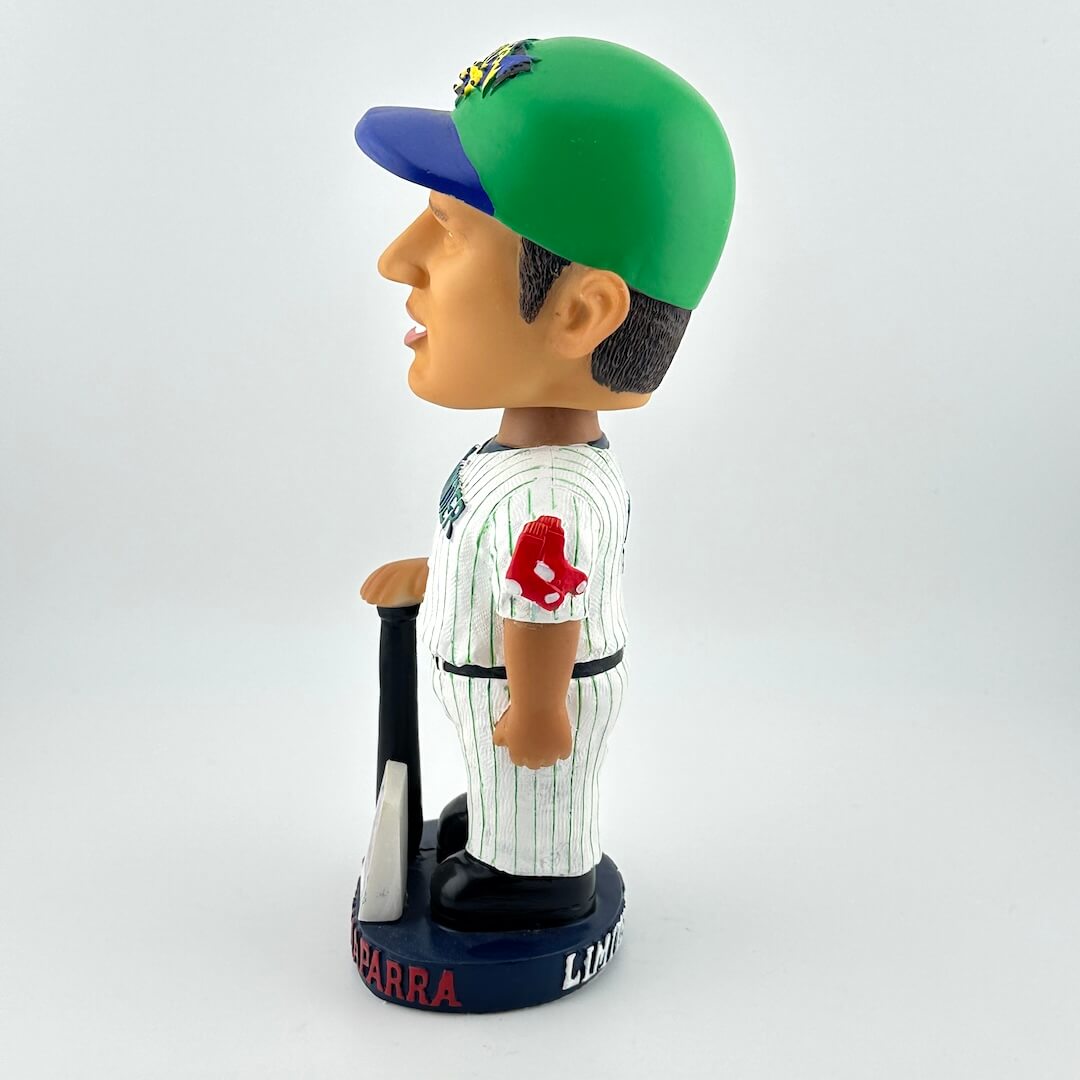Baseball bobblehead figure with green cap and white uniform on a white background