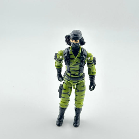 Action figure in green and black camouflage outfit on a white background