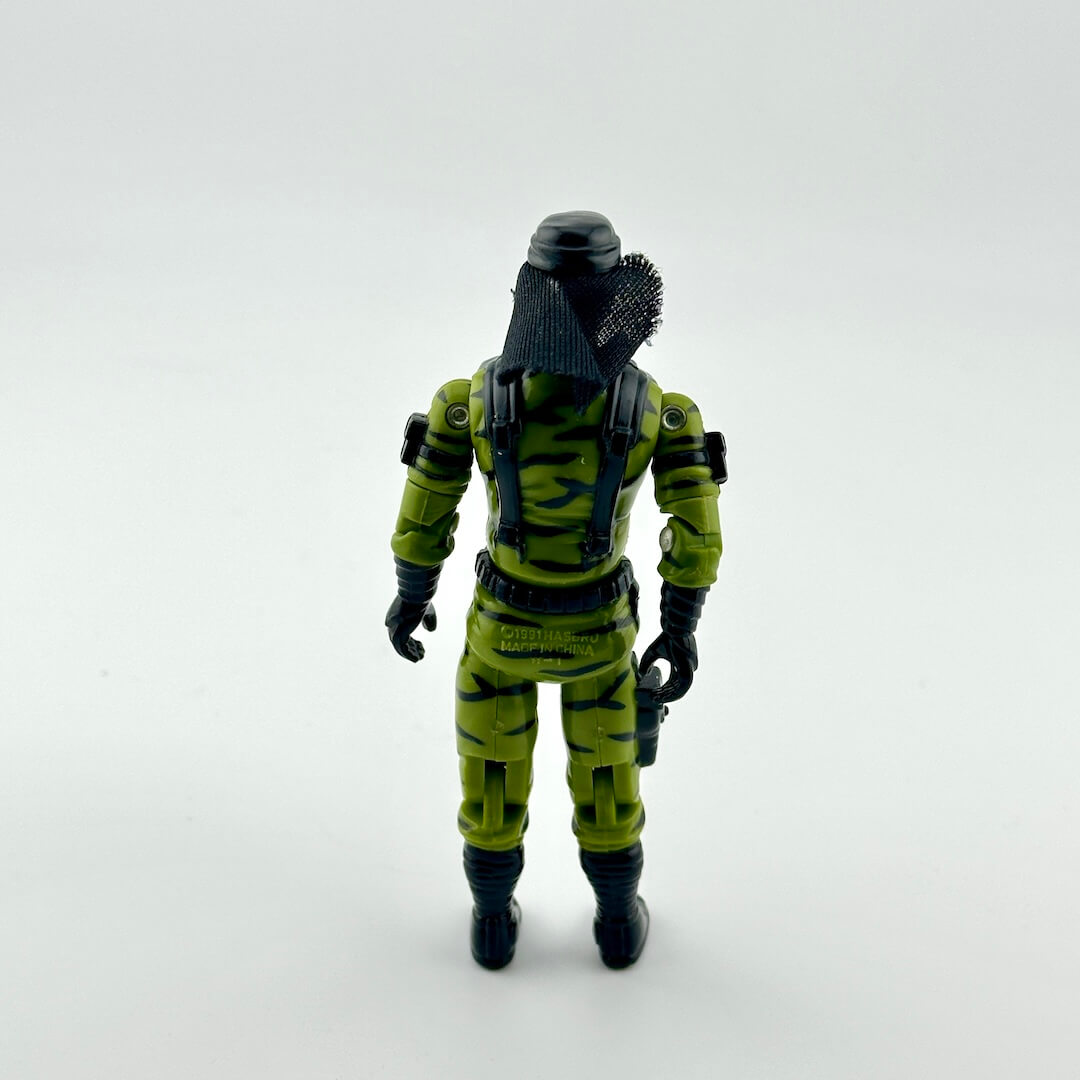 Action figure in a green camouflage suit with black helmet and gloves on a white background