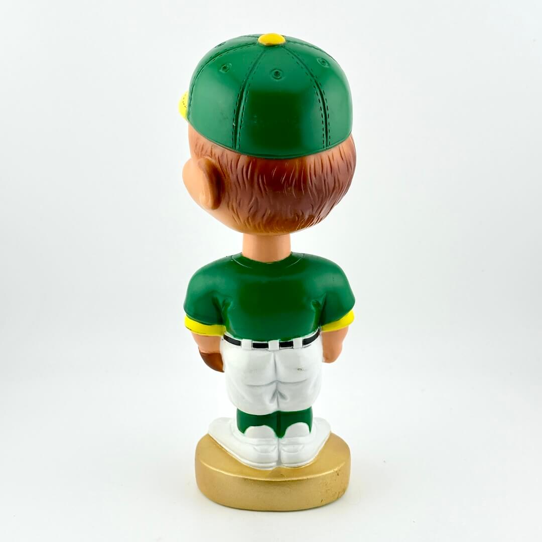 Bobblehead figure of a baseball player in a green uniform on a white background