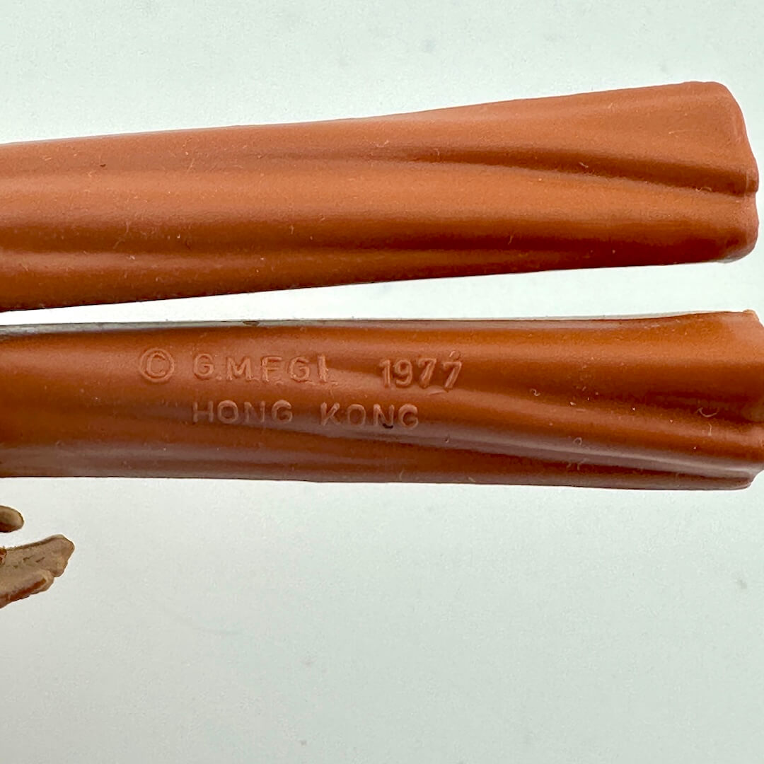 Close-up of back of figure's legs to show COO and copyright information. 