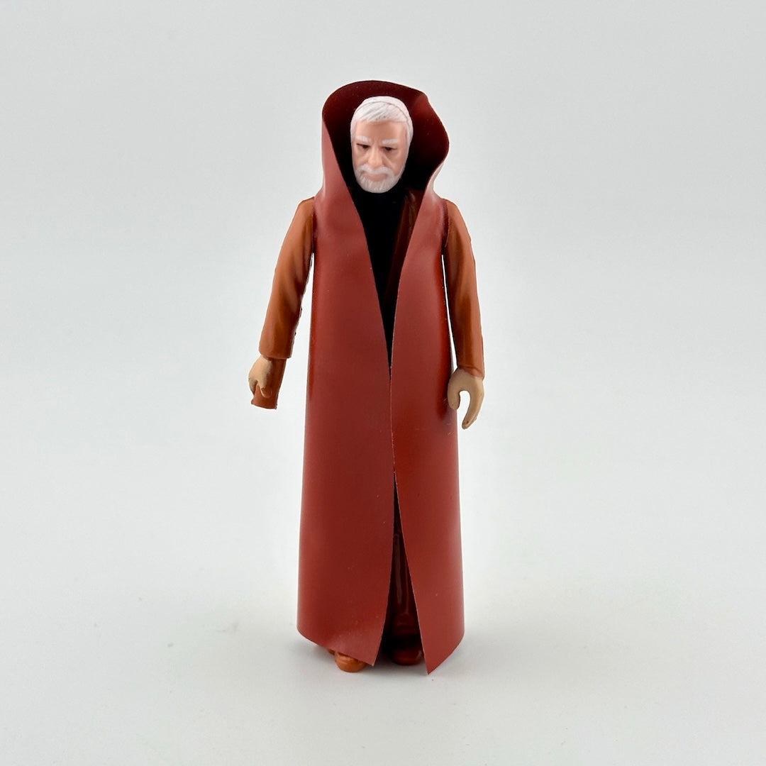 White haired male action figure with white beard dressed in all brown and brown cape. 