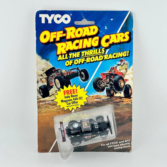Tyco off-road racing car packaging with two toy cars on a white background