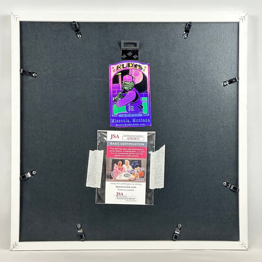 Back of a framed artwork with a JSA certification label on a gray background