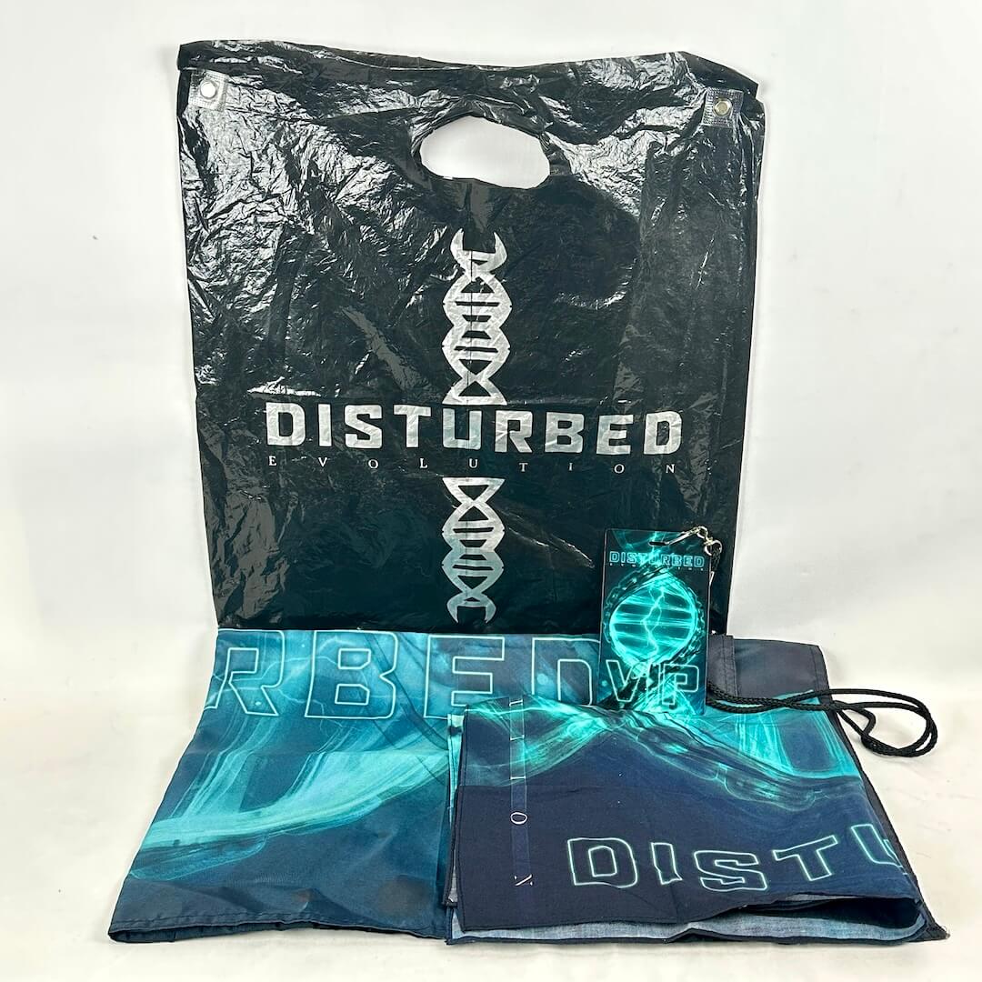 Black plastic bag with 'Disturbed' branding and a blue flag with similar design on a white background