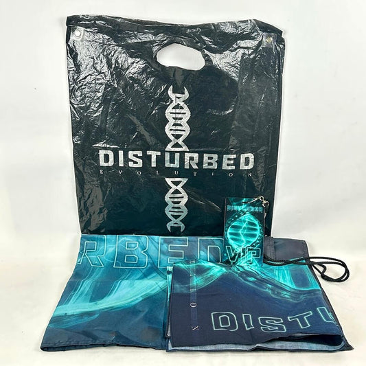 Black plastic bag with 'Disturbed' branding and a blue flag with similar design on a white background