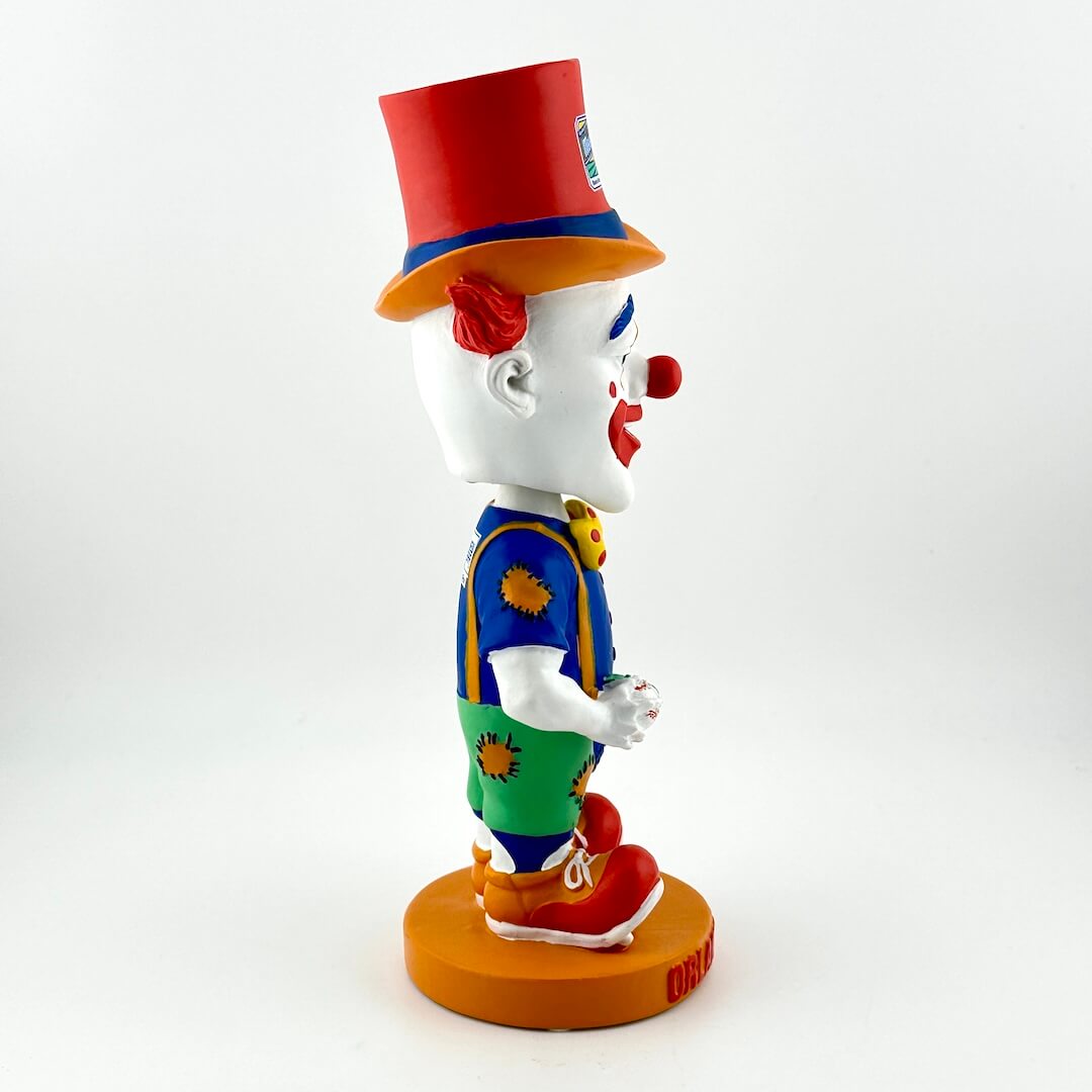 Colorful clown figurine with a red hat on a white background