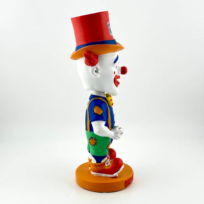 Colorful clown figurine with a red hat on a white background