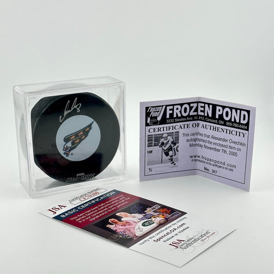 Clear square with signed hockey puck and two certificates of authentication.