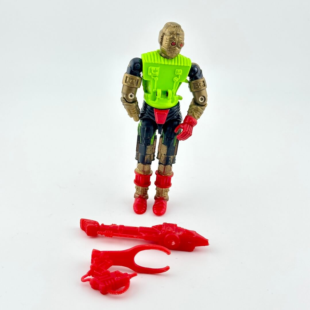 GI Joe action figure of cyborg with gold, black and red body, pictured with red accessories on white background.