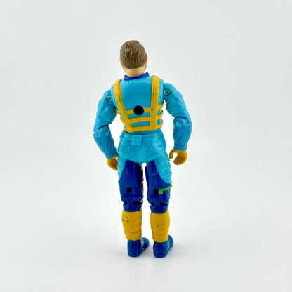GI Joe action figure in blue flight suit with yellow and green accents, photographed on white background. 