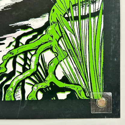 Green tree illustration on a black background with a magnet in the corner.
