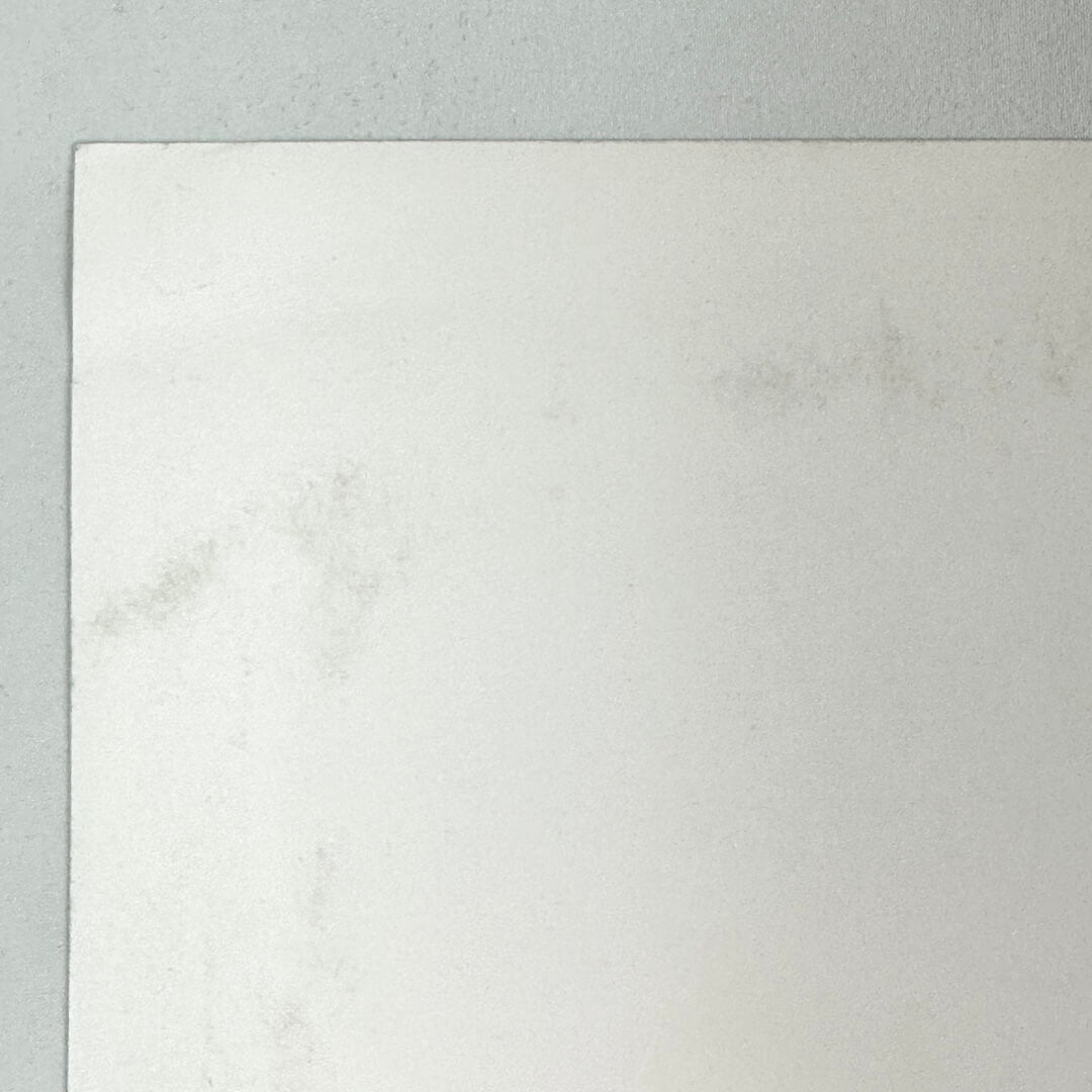 Top left corner of poster where there is some unnoticeable damage. 