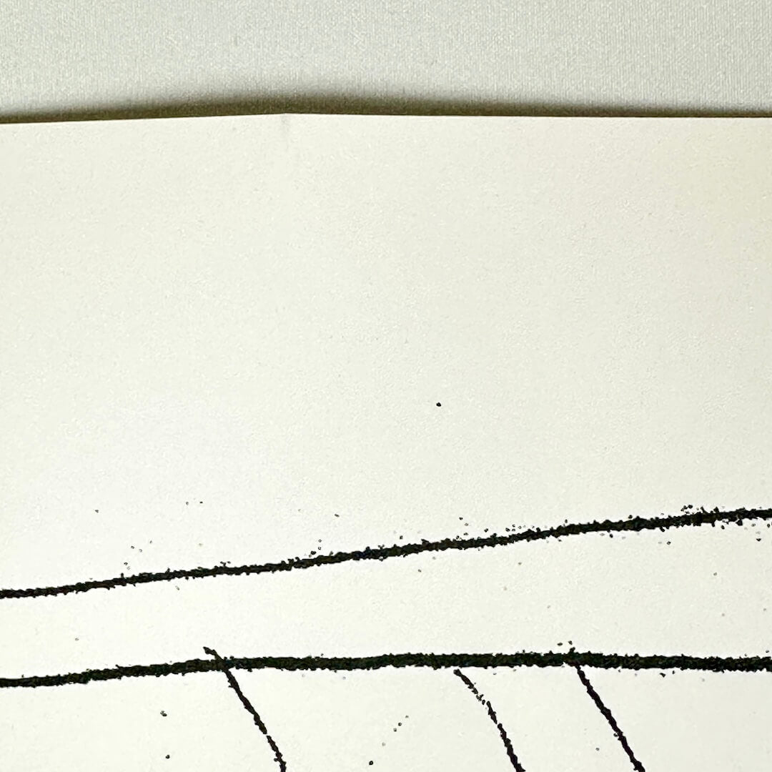Close-up of crease at top center of poster. 