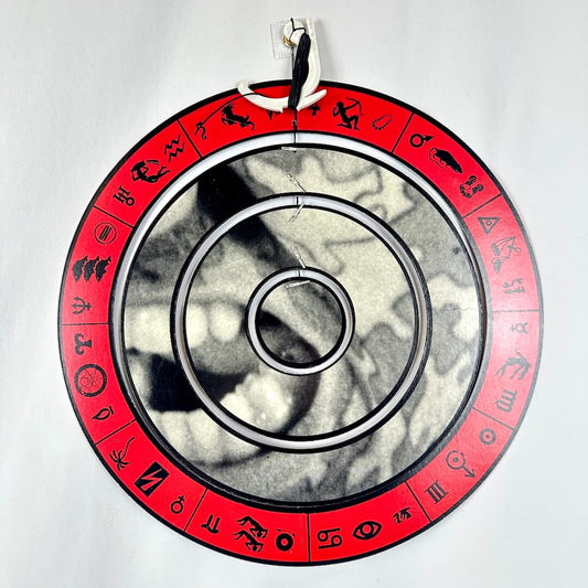 Circular object with red rim featuring symbols on a white background