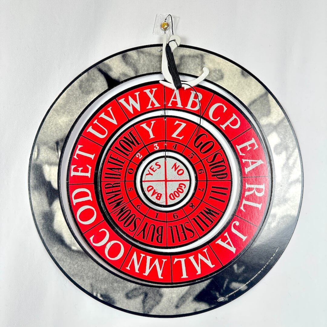 Decorative wheel with alphabet and yes/no symbols on a white background