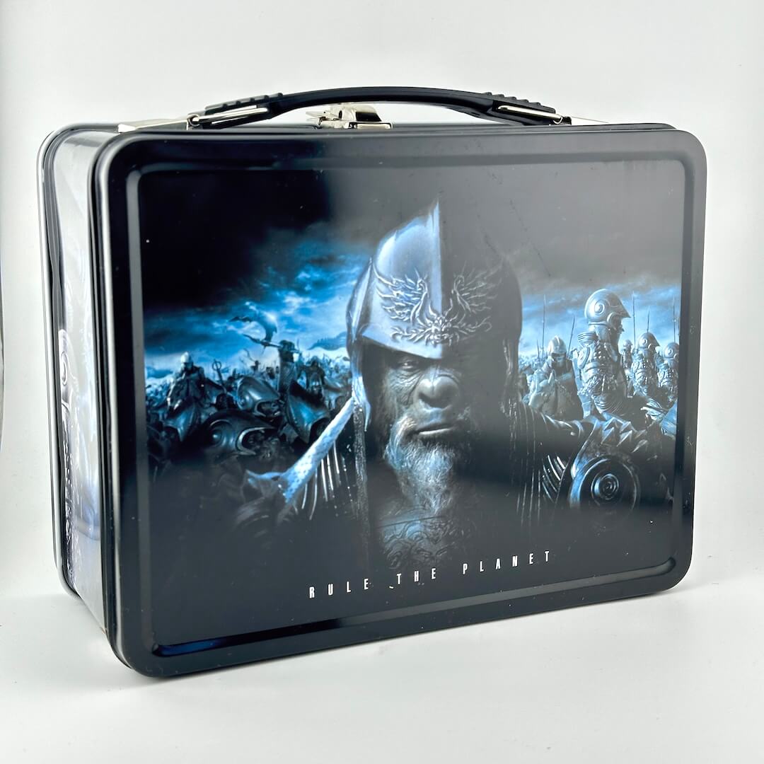 Planet of the Apes lunchbox with image of armored apes, photographed on gray background. 