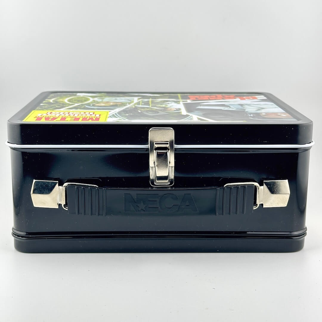 Top view of metal lunchbox showing black plastic handle, silver latch, and handle attachments. 
