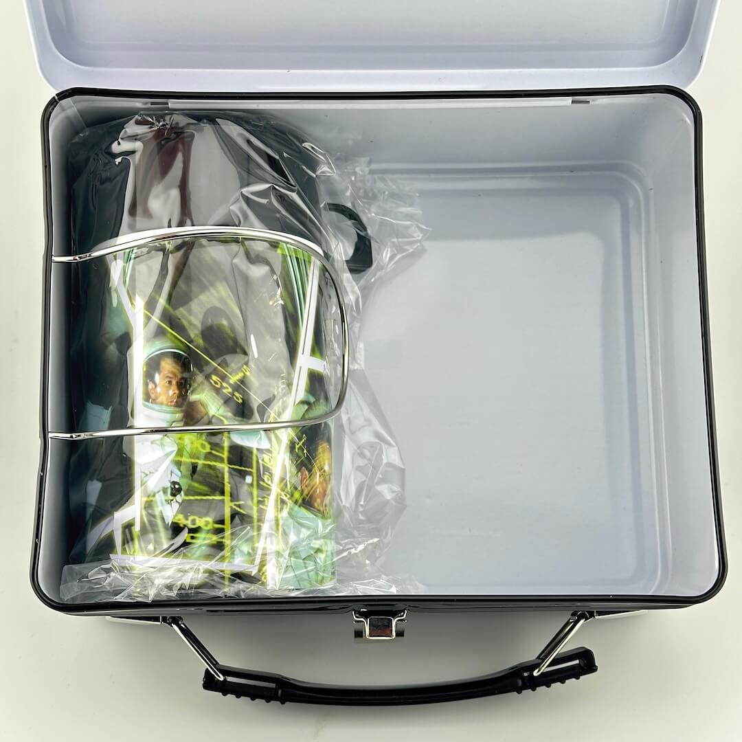Inside of metal lunchbox with matching thermos in original plastic packaging.