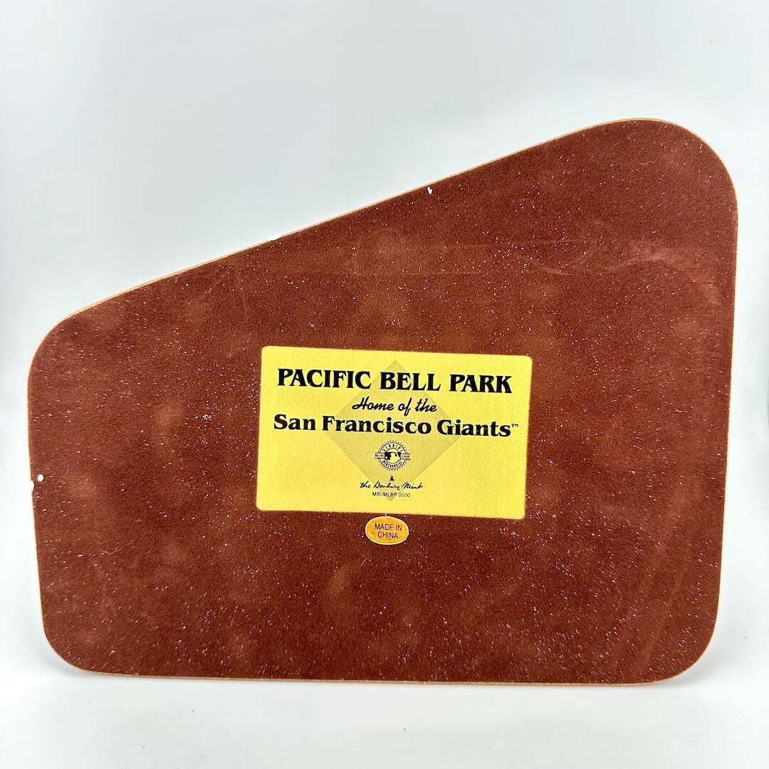 Brown leather base to replica with a gold label describing replica as Pacific Bell Park, home of the San Francisco Giants.