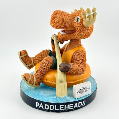 Figurine of a moose in an orange life jacket with a paddle, sitting on a blue base with 'Paddleheads' branding.