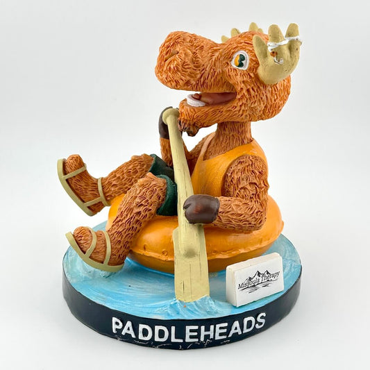 Figurine of a moose in an orange life jacket with a paddle, sitting on a blue base with 'Paddleheads' branding.