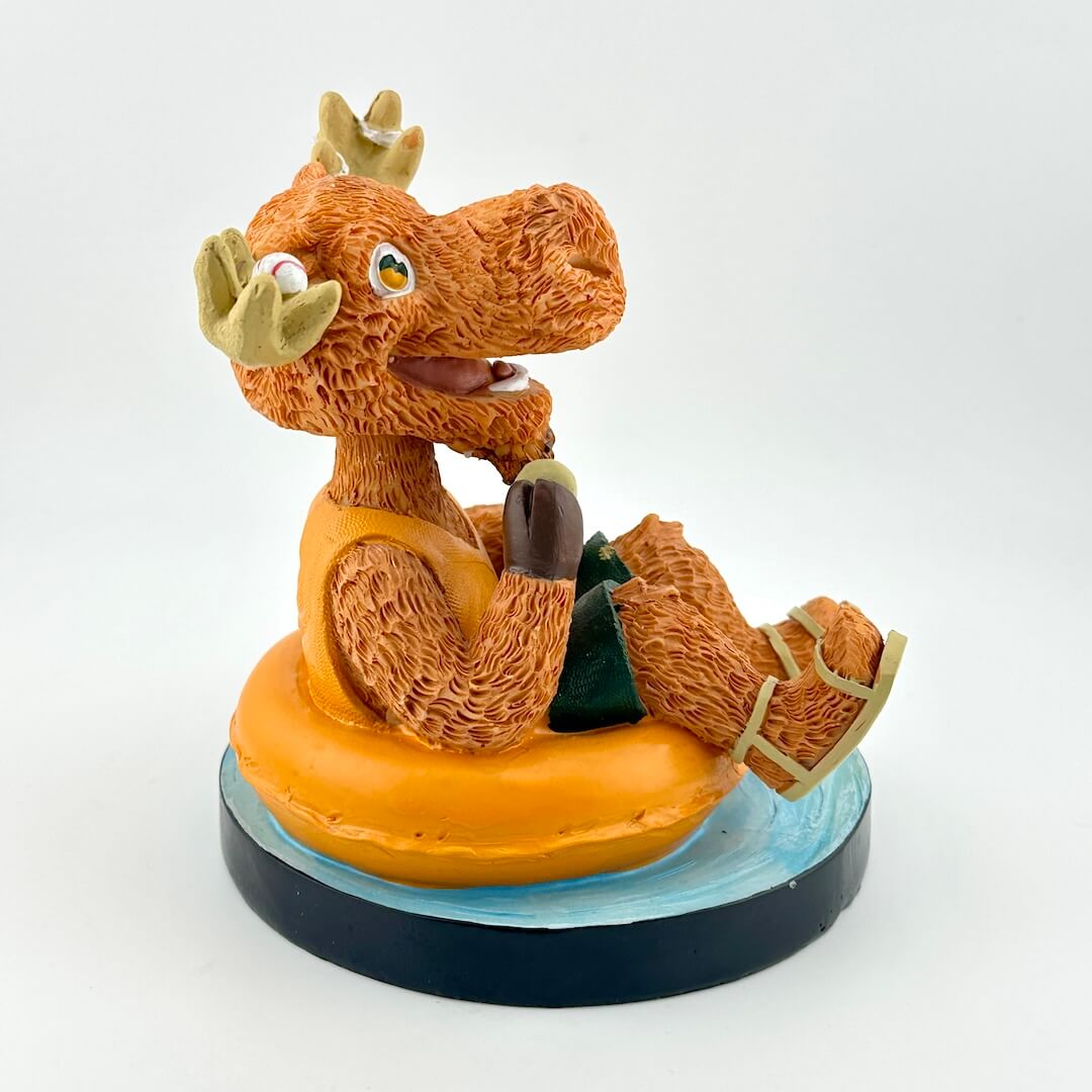 Toy figure of a brown moose on an orange life preserver against a white background